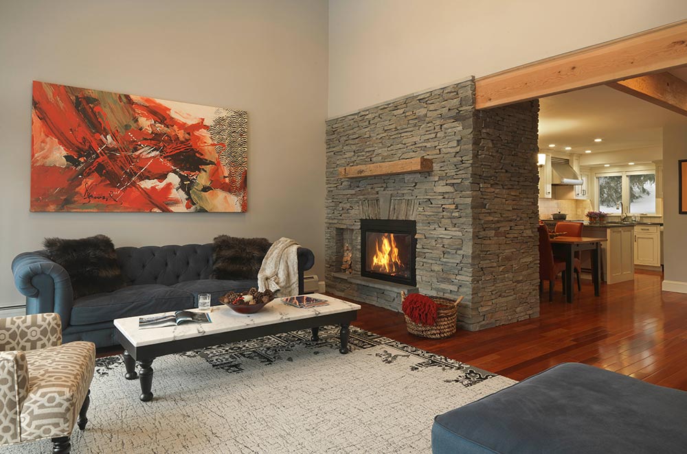comfortable living room with stone fireplace
