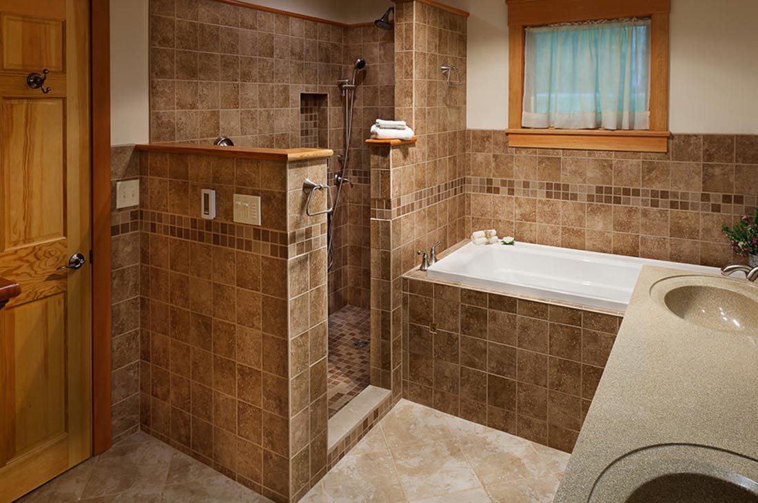 master bathroom with natural color tiles and shower
