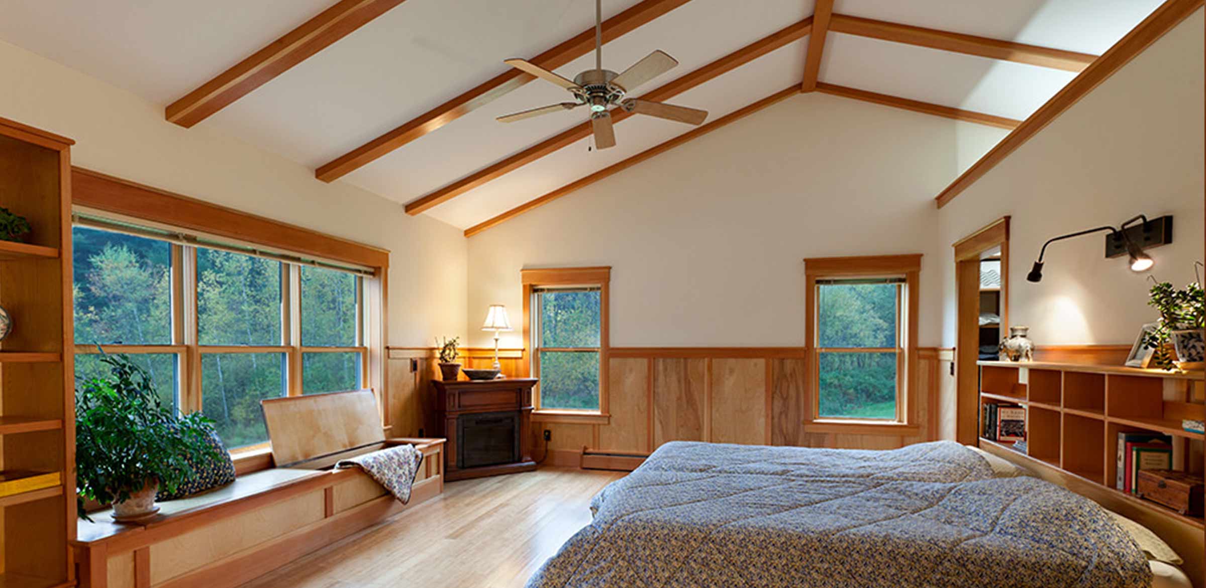 master bedroom with built in bench and exposed beams