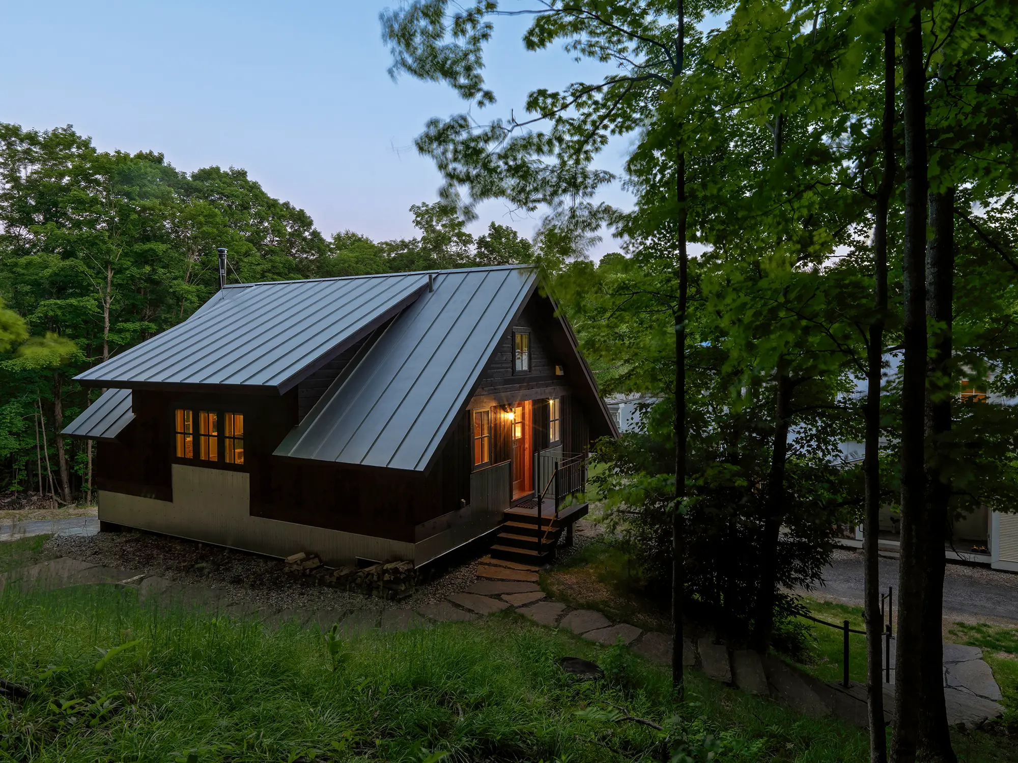 picture of the exterior of the home on hillside and in the trees